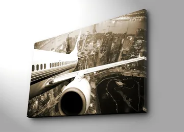 Canvastavla 70x100 cm - Ett flygplan som svävar över en stad i skymningsljus - Svart / Vit / Grå - Inredning - Tavlor & posters - Canvastavla