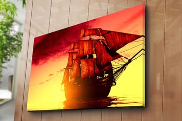 Canvastavla 70x100 cm - Ett majestätiskt segelfartyg med röda segel som navigerar genom en gyllene solnedgång - Röd / Orange / Gul - Inredning - Tavlor & posters - Canvastavla