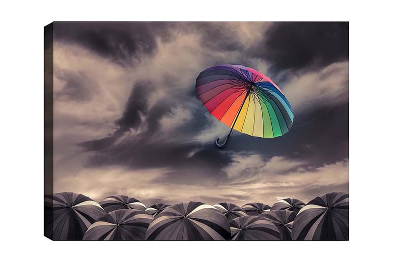 Canvastavla 70x100 cm - Färgglad paraply svävar över en samling gråa paraplyer under ett dramatiskt molnigt himmel, Regnbågsfärger / Grå