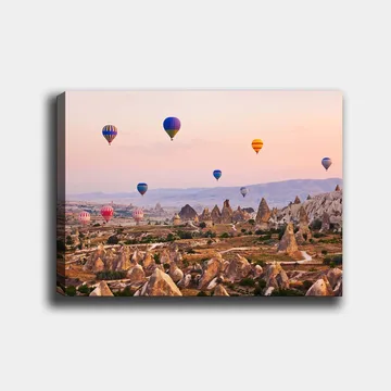 Canvastavla 70x100 cm - Flera färgglada luftballonger sväva över en dramatisk landskap med unika klippformationer - Blå / Röd / Orange - Inredning - Tavlor & posters - Canvastavla