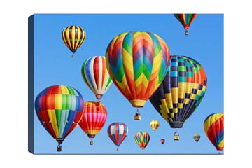 Canvastavla 70x100 cm - Flera färgglada varmluftsballonger sväva i en klar blå himmel - Röd / Grön / Gul - Inredning - Tavlor & posters - Canvastavla
