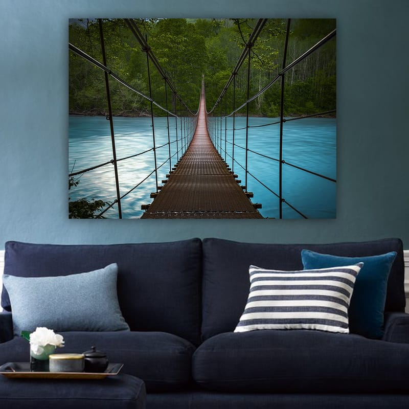 Canvastavla 70x100 cm - Hängbro som sträcker sig över en stilla, blå flod omgiven av grönskande träd - Mörkbrun / Turkos / Grön - Inredning - Tavlor & posters - Canvastavla
