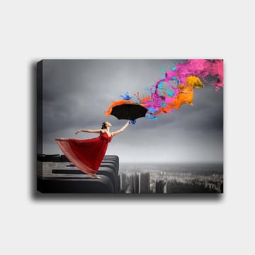 Canvastavla 70x100 cm - Kvinna i röd klänning står på en kant och håller ett paraply, medan färgglada färgstrålar sprutar ut från det - Röd / Svart / Orange - Inredning - Tavlor & posters - Canvastavla