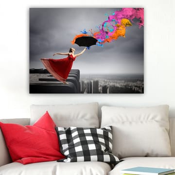 Canvastavla 70x100 cm - Kvinna i röd klänning står på en kant och håller ett paraply, medan färgglada färgstrålar sprutar ut från det - Röd / Svart / Orange - Inredning - Tavlor & posters - Canvastavla