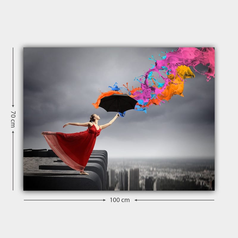 Canvastavla 70x100 cm - Kvinna i röd klänning står på en kant och håller ett paraply, medan färgglada färgstrålar sprutar ut från det - Röd / Svart / Orange - Inredning - Tavlor & posters - Canvastavla