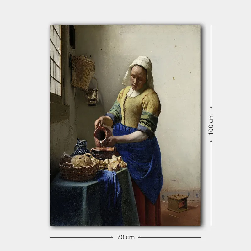 Canvastavla 70x100 cm - Kvinna som häller mjölk i en skål i ett ljust kök - Blå / Gul / Brun - Inredning - Tavlor & posters - Canvastavla