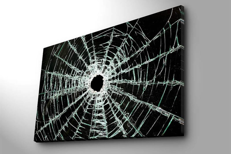 Canvastavla 70x100 cm - Närbild av en sprucken glasruta med ett centralt hål och sprickor som sträcker sig utåt - Svart / Genomskinlig - Inredning - Tavlor & posters - Canvastavla
