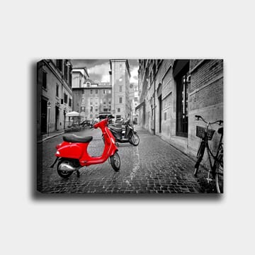 Canvastavla 70x100 cm - Röd scooter står i en svartvit stadsmiljö med kullerstensgator och byggnader - Röd / Svart / Grå - Inredning - Tavlor & posters - Canvastavla
