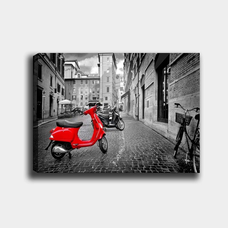 Canvastavla 70x100 cm - Röd scooter står i en svartvit stadsmiljö med kullerstensgator och byggnader, Röd / Svart / Grå