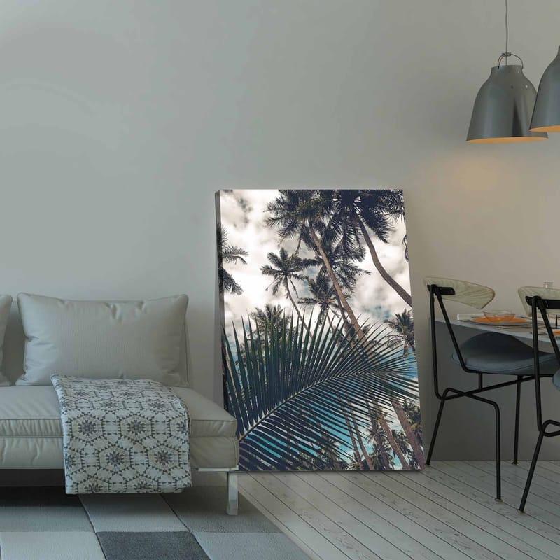 Canvastavla 70x100 cm - Tropisk palmlund med en stor palmblad i förgrunden - Mörkgrön / Ljusgrön / Blå - Inredning - Tavlor & posters - Canvastavla