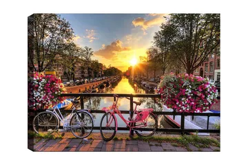Canvastavla 70x100 cm - Två cyklar i en pittoresk kanalmiljö med blommor och solnedgång - Rosa / Vit / Grön - Inredning - Tavlor & posters - Canvastavla