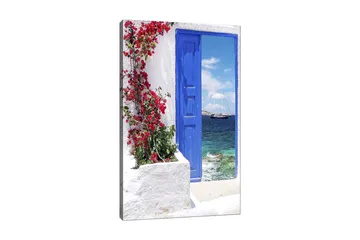 Canvastavla 70x100 cm - Vacker blå dörr omgiven av blommor i rött som leder ut mot en havsutsikt - Blå / Röd / Grön - Inredning - Tavlor & posters - Canvastavla