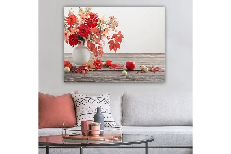Canvastavla 70x100 cm - Vacker bukett med röda och orange blommor i en vit vas, omgiven av höstlöv och frukter - Röd / Orange / Grön - Inredning - Tavlor & posters - Canvastavla
