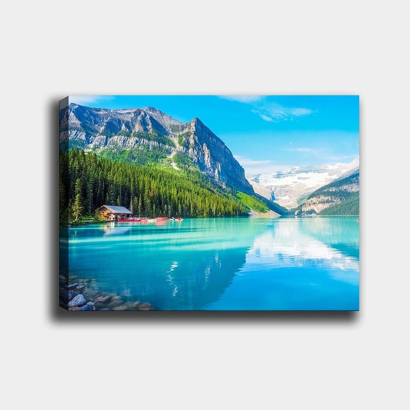 Canvastavla 70x100 cm - Vacker sjö omgiven av majestätiska berg och tät grönska, Turkos / Grön / Blå