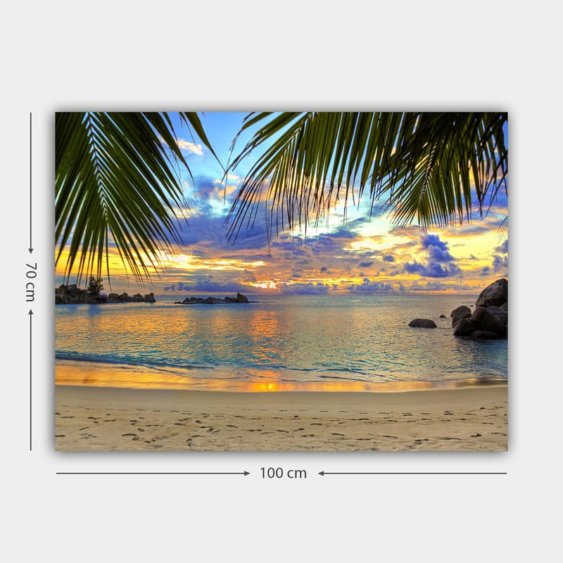 Canvastavla 70x100 cm - Vacker solnedgång över en strand med palmer som ramar in motivet - Blå / Orange / Grön - Inredning - Tavlor & posters - Canvastavla