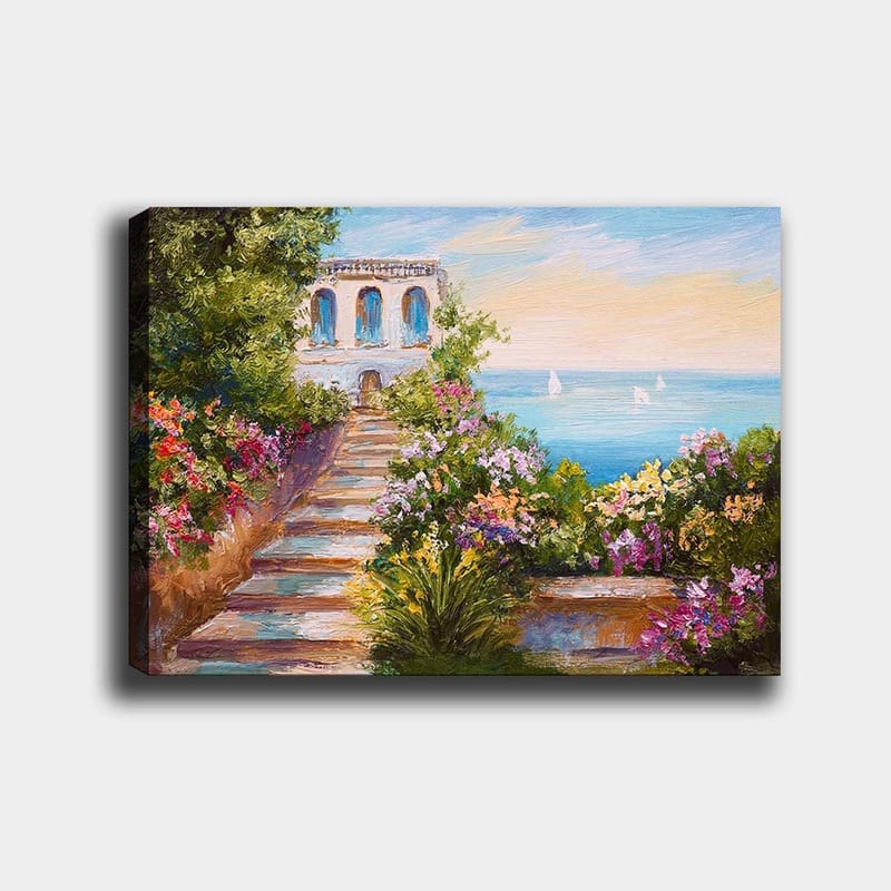 Canvastavla 70x100 cm - Vacker trappa omgiven av färgglada blommor som leder ner till havet och en byggnad med blå fönster, Grön / Rosa / Blå