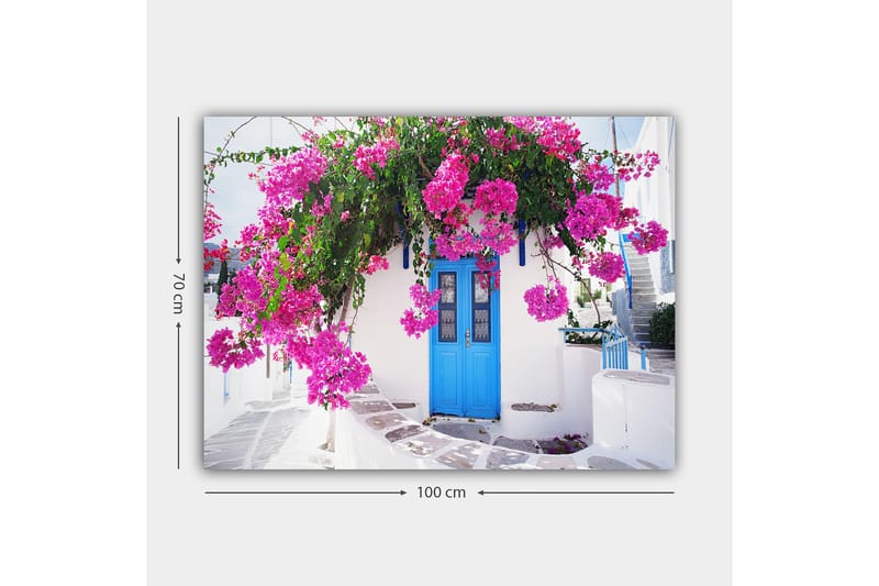 Canvastavla 70x100 cm - Vacker vit byggnad med en blå dörr omgiven av lila blommor - Lila / Blå / Grön - Inredning - Tavlor & posters - Canvastavla