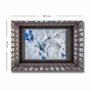 Canvastavla 70x100 cm - Vy av en byggnadsfasad som ramar in en spegelbild av himlen - Mörkbrun / Vit / Ljusblå - Inredning - Tavlor & posters - Canvastavla