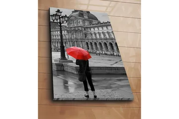 Canvastavla 70x100 cm - Person står med ett rött paraply i en regnig stadsmiljö framför en historisk byggnad - Röd / Svart - Inredning - Tavlor & posters - Canvastavla