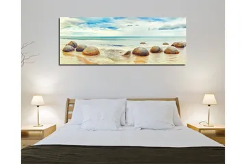 Canvastavla 80x30 cm - Runda stenar vid en strand med hav och himmel i bakgrunden - Blå / Beige / Grå - Inredning - Tavlor & posters - Canvastavla