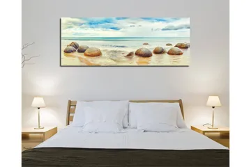 Canvastavla 80x30 cm - Runda stenar vid en strand med hav och himmel i bakgrunden - Blå / Beige / Grå - Inredning - Tavlor & posters - Canvastavla