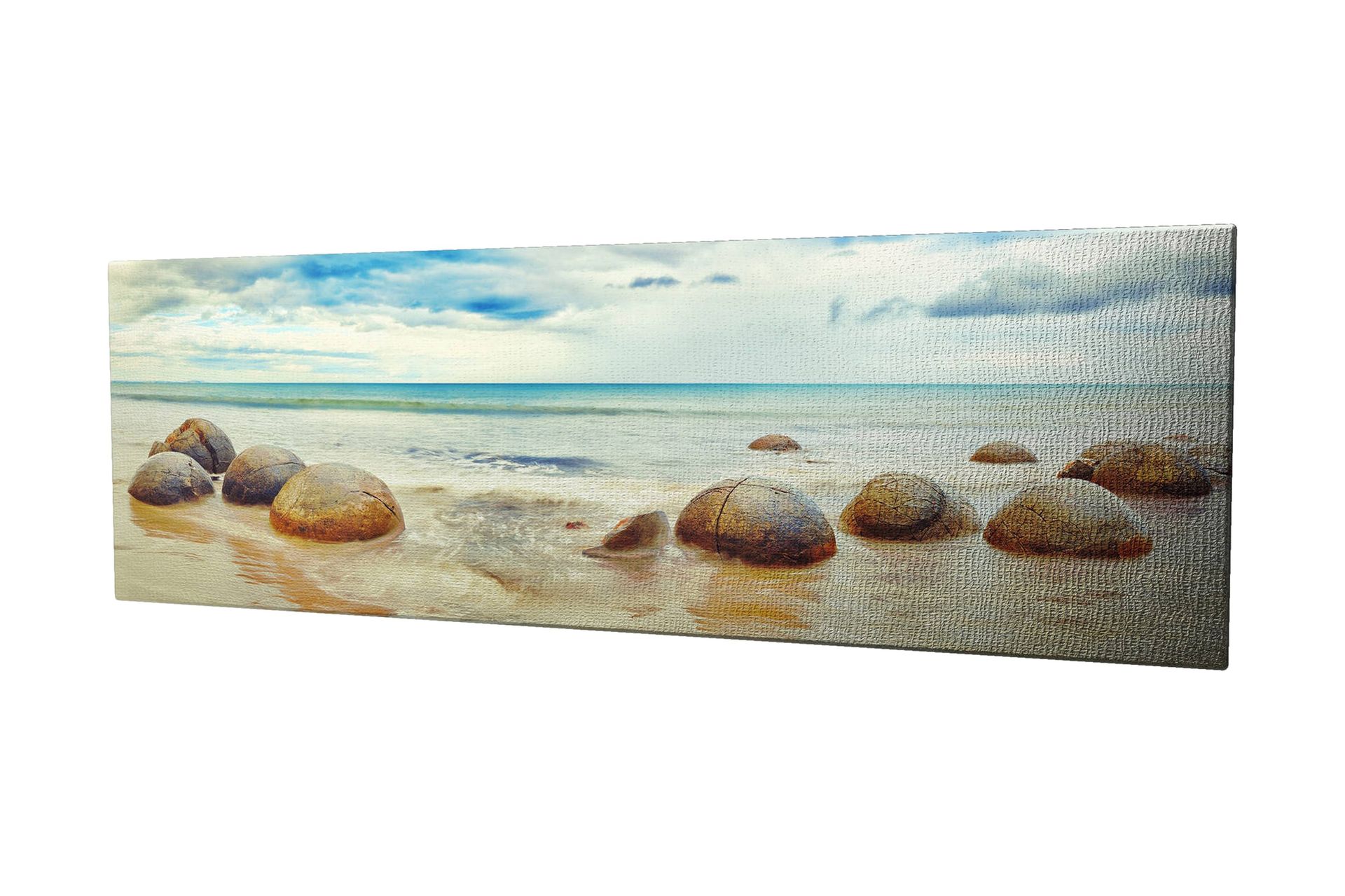 Canvastavla 80x30 cm - Runda stenar vid en strand med hav och himmel i bakgrunden - Blå / Beige / Grå