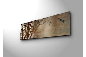 Canvastavla med LED-belysning 30x90 cm - Silhuett av träd med en fågel i flykt mot en mjukt tonad bakgrund - Mörkbrun / Beige / Svart - Inredning - Tavlor & posters - Canvastavla