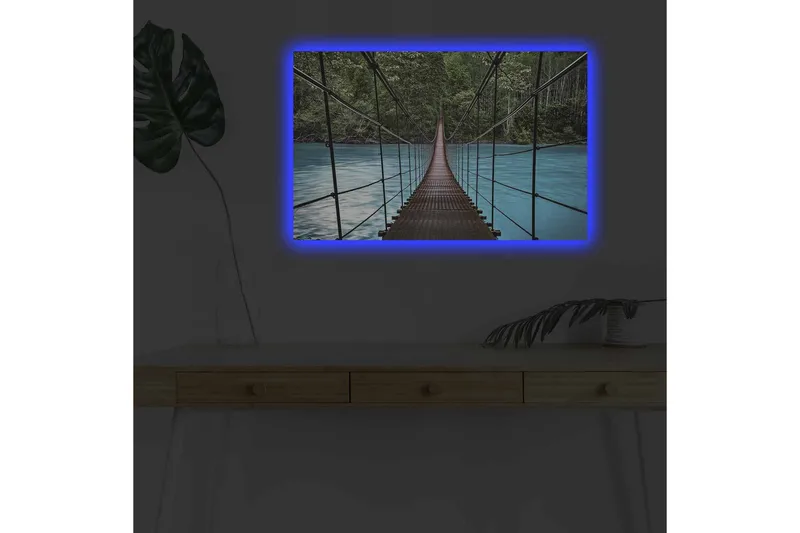 Canvastavla med LED-belysning - Hängbro över en klarblå flod omgiven av grönskande natur, Grön / Blå / Brun