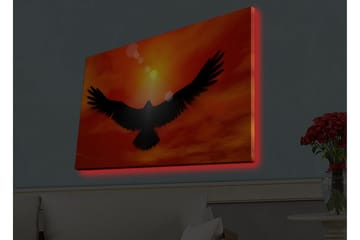 Canvastavla med LED-belysning - Silhuett av en örn som flyger mot en solnedgång i starka färger - Röd / Svart / Orange - Inredning - Tavlor & posters - Canvastavla