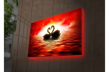 Canvastavla med LED-belysning - Två svanar som formar ett hjärta mot en dramatisk solnedgång - Röd / Svart / Orange - Inredning - Tavlor & posters - Canvastavla