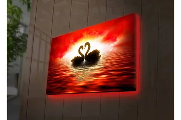 Canvastavla med LED-belysning - Två svanar som formar ett hjärta mot en dramatisk solnedgång - Röd / Svart / Orange - Inredning - Tavlor & posters - Canvastavla