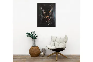 Canvastavla - Svart panter med intensiva ögon som slickar sin tass - Svart / Guld / Mörkgrön - Inredning - Tavlor & posters - Canvastavla